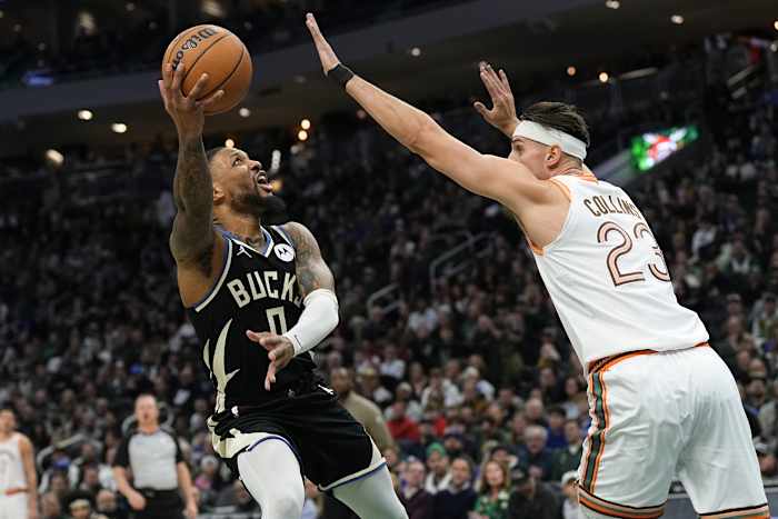 Milwaukee Bucks guard Damian Lillard (0) shoots around San Antonio Spurs center Zach Collins (23)